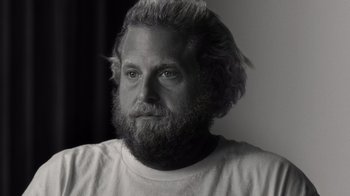 Movie still from “Stutz” (2022), directed by Jonah Hill – Black and white photograph of a man with long hair and a beard; Close Up shot, Low angle