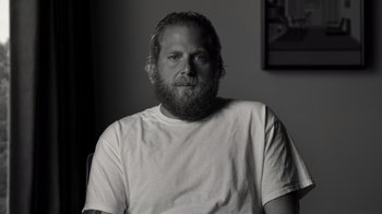 Movie still from “Stutz” (2022), directed by Jonah Hill – Black and white photograph of a man with a beard; Close Up shot, Over the shoulder angle