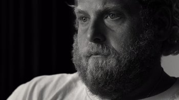 Movie still from “Stutz” (2022), directed by Jonah Hill – Black and white photograph of a man with a long beard; Close Up shot, Over the shoulder angle
