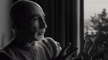 Movie still from “Stutz” (2022), directed by Jonah Hill – An older man is looking out a window; Close Up shot, Low angle