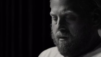 Movie still from “Stutz” (2022), directed by Jonah Hill – Black and white photograph of a man with a beard; Close Up shot, Over the shoulder angle