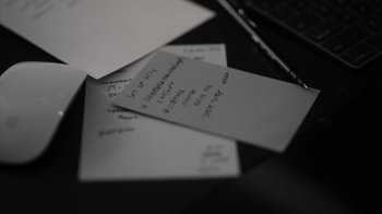 Movie still from “Stutz” (2022), directed by Jonah Hill – View of a bunch of notes on a table; Extreme Close Up shot, High angle
