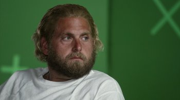 Movie still from “Stutz” (2022), directed by Jonah Hill – A man with long hair and a beard looking to his left; Close Up shot, Over the shoulder angle