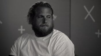 Movie still from “Stutz” (2022), directed by Jonah Hill – Black and white photograph of a man with a beard; Close Up shot, Over the shoulder angle