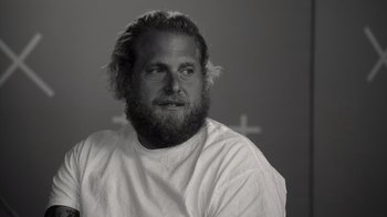 Movie still from “Stutz” (2022), directed by Jonah Hill – Black and white photograph of a man with a beard; Close Up shot, Over the shoulder angle