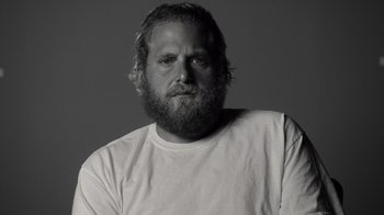 Movie still from “Stutz” (2022), directed by Jonah Hill – Black and white photograph of a man with a beard; Close Up shot, Low angle