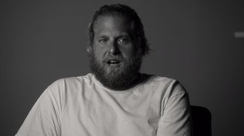 Movie still from “Stutz” (2022), directed by Jonah Hill – Black and white photograph of a man with a long beard; Close Up shot, Over the shoulder angle