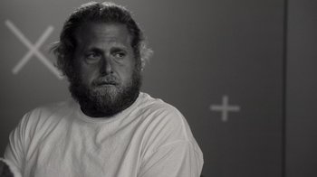 Movie still from “Stutz” (2022), directed by Jonah Hill – Black and white photograph of a man with a beard; Close Up shot, Over the shoulder angle