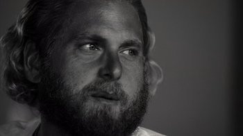 Movie still from “Stutz” (2022), directed by Jonah Hill – Black and white photograph of a man with a beard; Close Up shot, Low angle
