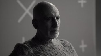 Movie still from “Stutz” (2022), directed by Jonah Hill – An older man with a bald head wearing a sweater; Close Up shot, Over the shoulder angle