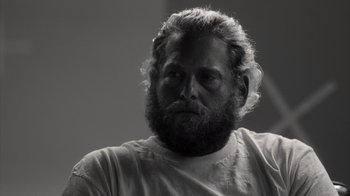 Movie still from “Stutz” (2022), directed by Jonah Hill – Black and white photograph of a man with a beard; Close Up shot, Low angle