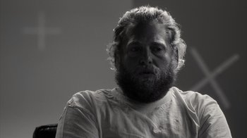 Movie still from “Stutz” (2022), directed by Jonah Hill – Black and white photograph of a man with a beard; Close Up shot, Over the shoulder angle