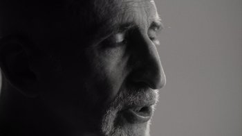 Movie still from “Stutz” (2022), directed by Jonah Hill – A person's face with a beard; Close Up shot, Low angle