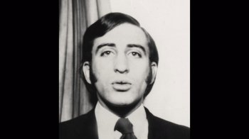 Movie still from “Stutz” (2022), directed by Jonah Hill – A black and white photo of a man wearing a suit and tie; Close Up shot, High angle