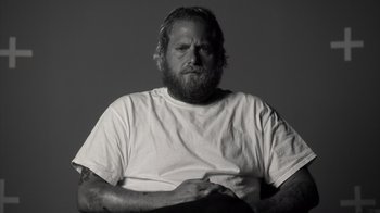 Movie still from “Stutz” (2022), directed by Jonah Hill – Black and white photograph of a man with a beard; Medium shot, Low angle