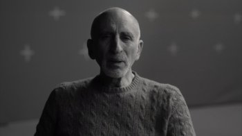 Movie still from “Stutz” (2022), directed by Jonah Hill – An older man wearing a sweater and a sweater; Close Up shot, Over the shoulder angle