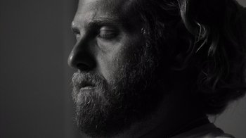 Movie still from “Stutz” (2022), directed by Jonah Hill – A person with a beard; Close Up shot, Low angle