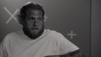 Movie still from “Stutz” (2022), directed by Jonah Hill – Black and white photograph of a man with a beard; Close Up shot, Over the shoulder angle
