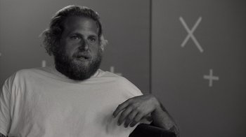 Movie still from “Stutz” (2022), directed by Jonah Hill – Black and white photograph of a man with a beard; Close Up shot, Over the shoulder angle