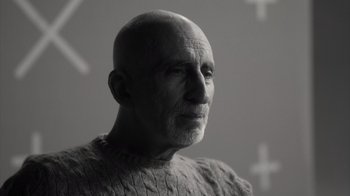 Movie still from “Stutz” (2022), directed by Jonah Hill – An older man with a bald head wearing a sweater; Close Up shot, Low angle