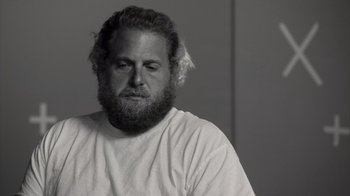 Movie still from “Stutz” (2022), directed by Jonah Hill – Black and white photograph of a man with a beard; Close Up shot, Low angle