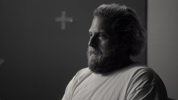 Movie still from “Stutz” (2022), directed by Jonah Hill – Black and white photograph of a man with a beard; Close Up shot, Over the shoulder angle