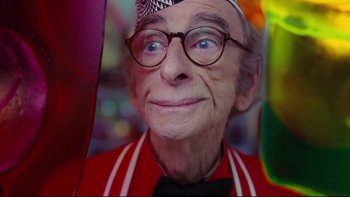 Movie still from “Charlie and the Chocolate Factory” (2005), directed by Tim Burton – An older man wearing a hat and glasses; Close Up shot, Low angle
