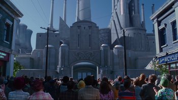 Movie still from “Charlie and the Chocolate Factory” (2005), directed by Tim Burton – A crowd of people standing in front of a large building; Extreme Wide shot, Low angle