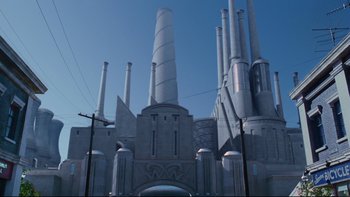 Movie still from “Charlie and the Chocolate Factory” (2005), directed by Tim Burton – A building that has many pipes on top of it; Extreme Wide shot, Low angle