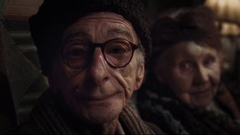 Movie still from “Charlie and the Chocolate Factory” (2005), directed by Tim Burton – An old man wearing glasses and a hat; Close Up shot, Low angle