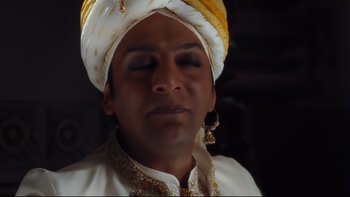 Movie still from “Charlie and the Chocolate Factory” (2005), directed by Tim Burton – A person wearing a turban; Close Up shot, Low angle