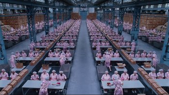 Movie still from “Charlie and the Chocolate Factory” (2005), directed by Tim Burton – An overhead view of a warehouse filled with workers; Extreme Wide shot, High angle