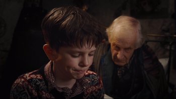Movie still from “Charlie and the Chocolate Factory” (2005), directed by Tim Burton – An older man and a young boy looking at each other; Close Up shot, Over the shoulder angle