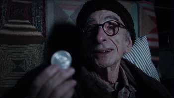 Movie still from “Charlie and the Chocolate Factory” (2005), directed by Tim Burton – An old man holding a bottle in his hand; Close Up shot, Over the shoulder angle