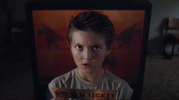 Movie still from “Charlie and the Chocolate Factory” (2005), directed by Tim Burton – A young boy holding a ticket in front of a painting; Close Up shot, High angle