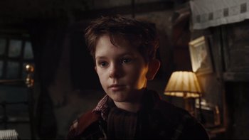 Movie still from “Charlie and the Chocolate Factory” (2005), directed by Tim Burton – A young boy is looking into the camera; Close Up shot, Low angle