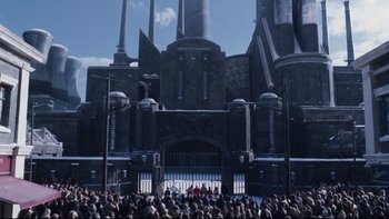 Movie still from “Charlie and the Chocolate Factory” (2005), directed by Tim Burton – A crowd of people standing in front of a large building; Extreme Wide shot, High angle