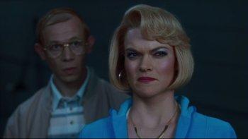 Movie still from “Charlie and the Chocolate Factory” (2005), directed by Tim Burton – A man and a woman are standing in a dark room; Close Up shot, Low angle