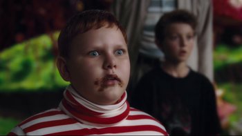 Movie still from “Charlie and the Chocolate Factory” (2005), directed by Tim Burton – A young boy with a red and white striped shirt; Close Up shot, Over the shoulder angle