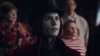 Movie still from “Charlie and the Chocolate Factory” (2005), directed by Tim Burton – A woman wearing a top hat in a crowd of people; Close Up shot, Over the shoulder angle
