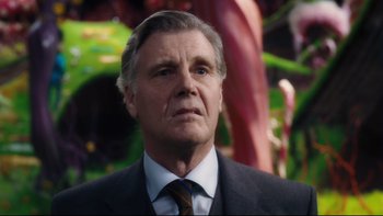 Movie still from “Charlie and the Chocolate Factory” (2005), directed by Tim Burton – An older man wearing a suit and tie; Close Up shot, Low angle