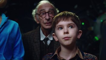 Movie still from “Charlie and the Chocolate Factory” (2005), directed by Tim Burton – An old man and a young boy are looking at the camera; Close Up shot, Over the shoulder angle