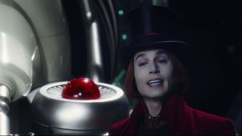 Movie still from “Charlie and the Chocolate Factory” (2005), directed by Tim Burton – A woman wearing a top hat next to an apple; Close Up shot, Low angle