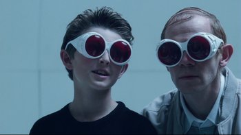 Movie still from “Charlie and the Chocolate Factory” (2005), directed by Tim Burton – A man and a boy wearing red glasses; Close Up shot, Low angle