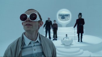 Movie still from “Charlie and the Chocolate Factory” (2005), directed by Tim Burton – A group of people standing in a room; Medium shot, Low angle