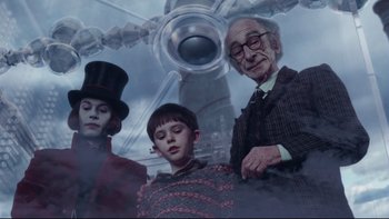 Movie still from “Charlie and the Chocolate Factory” (2005), directed by Tim Burton – A group of people standing next to each other in front of an airplane; Medium shot, Low angle