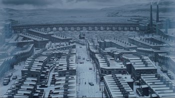 Movie still from “Charlie and the Chocolate Factory” (2005), directed by Tim Burton – An aerial view of a city covered in snow; Extreme Wide shot, High angle
