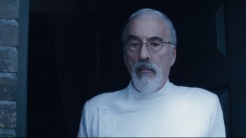 Movie still from “Charlie and the Chocolate Factory” (2005), directed by Tim Burton – An older man with a beard wearing glasses; Close Up shot, Low angle
