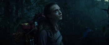 Movie still from “Suicide Squad” (2016), directed by David Ayer – A woman with a backpack looking up at the sky; Close Up shot, Low angle