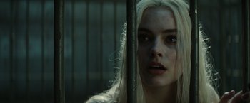 Movie still from “Suicide Squad” (2016), directed by David Ayer – A woman with long white hair looking out of a window; Close Up shot, Over the shoulder angle